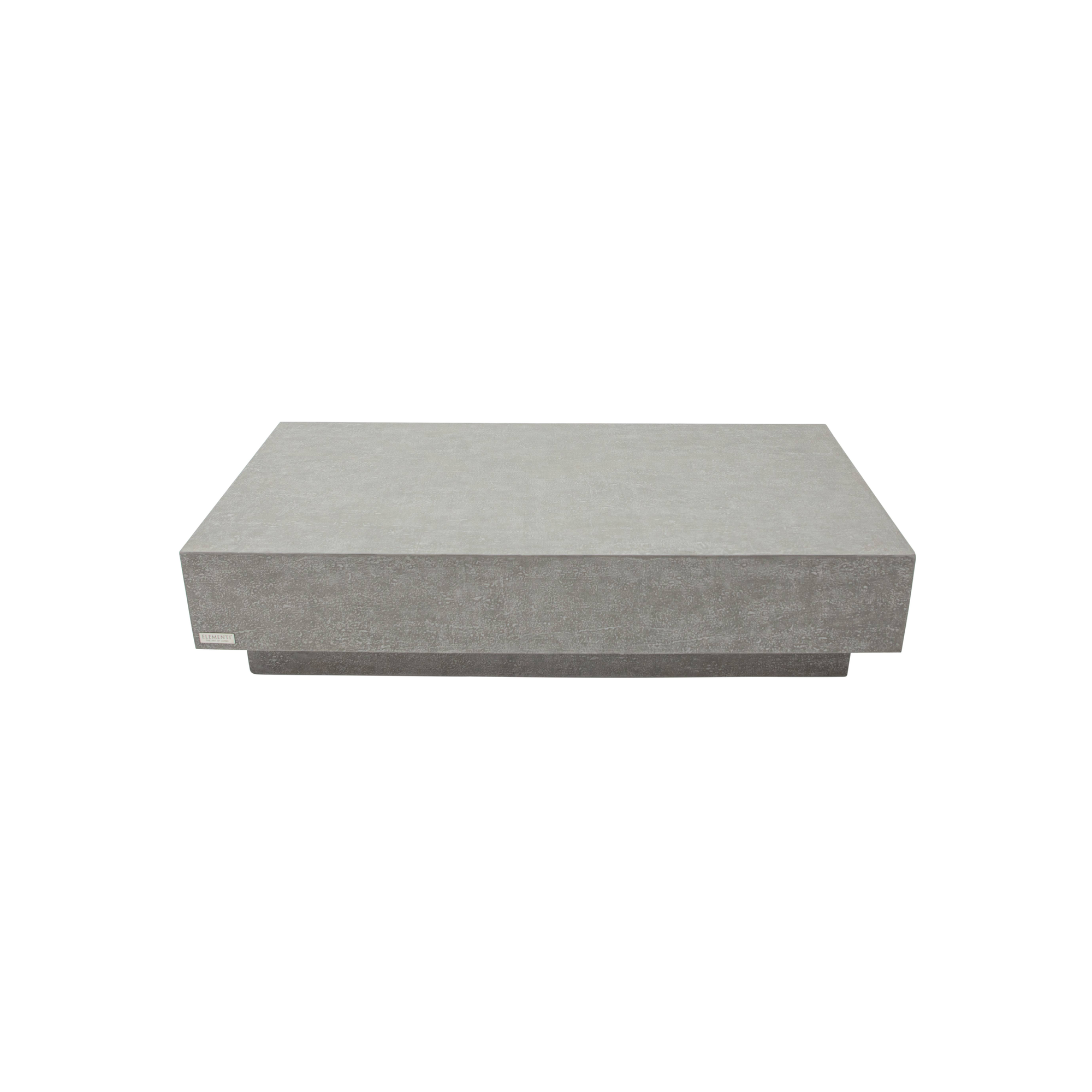 Table basse en béton de forme ronde devant un canapé